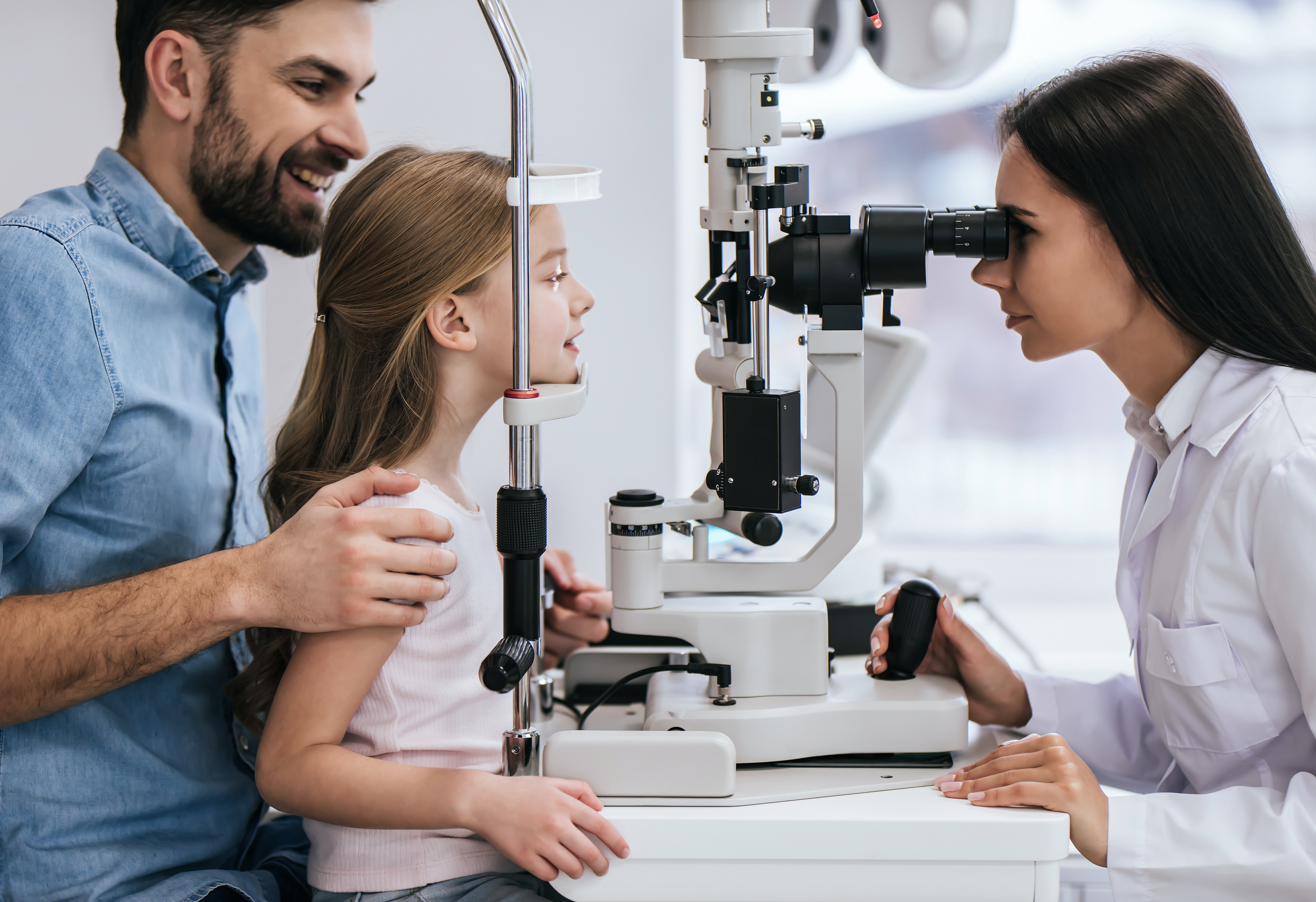 Eye doctor with young patient